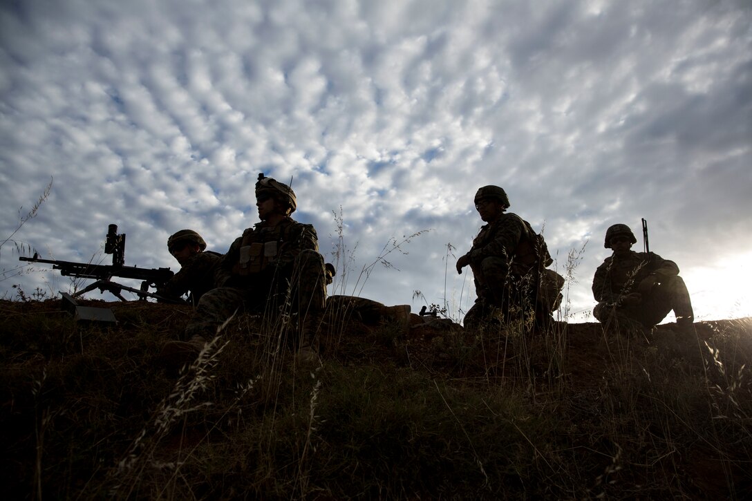 U.S. Marines with Special Purpose Marine Air-Ground Task Force-Crisis Response-Africa 19.2, Marine Forces Europe and Africa, prepare to fire their M240B machine guns during a squad attack on Campo De Maniobras, Base General Menacho, Spain, June 18, 2019. The Marines integrated with Spanish army operations to enhance interoperability with Spanish allies. SPMAGTF-CR-AF is deployed to conduct crisis-response and theater-security operations in Africa and promote regional stability by conducting military-to-military training exercises throughout Europe and Africa. (U.S. Marine Corps photo by Cpl. Margaret Gale)