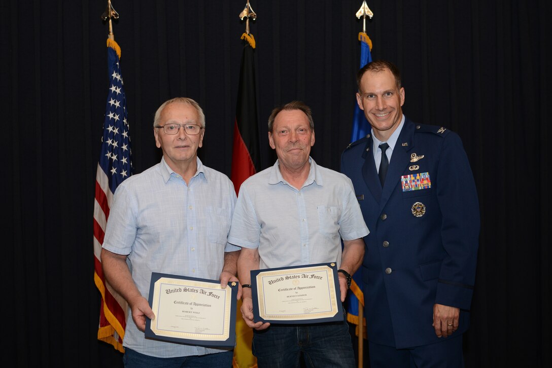 Recipients of the Civilian Length of Service award stand with U.S. Air Force Col. Matthew Husemann, 86th Airlift Wing vice commander, for a group photo during a ceremony on Ramstein Air Base, Germany, June 27, 2019. The recipients served 45 years of continued service to the U.S. Armed Forces. (U.S. Air Force photo by Airman 1st Class Jennifer Gonzales)