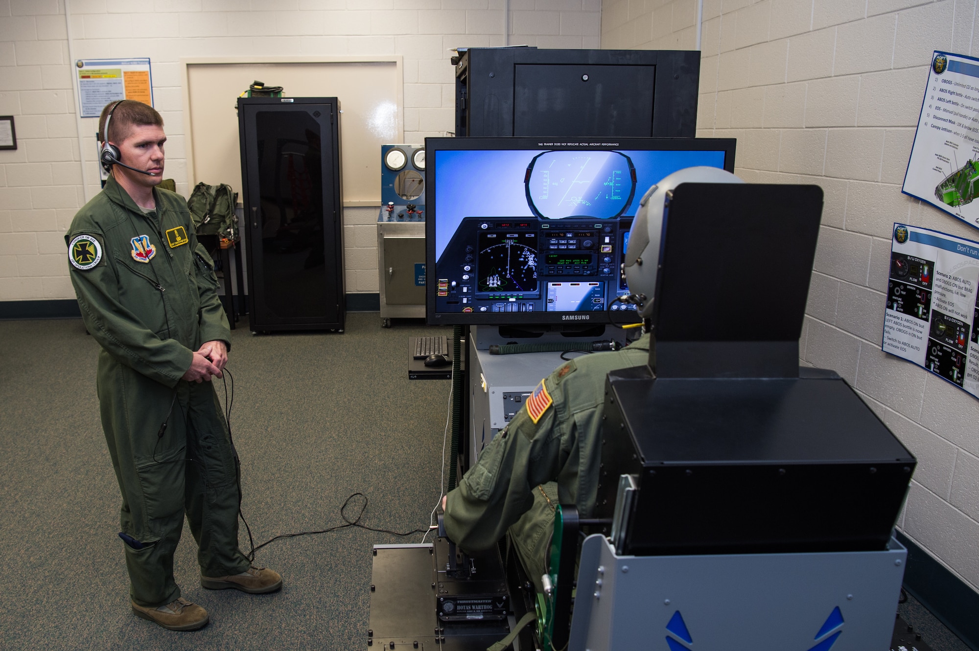 U.S. Air Force Master Sgt. Christopher Hoopes, 1st Operations Group Aerospace and Operational Physiology flight chief instructs an F-22 Raptor Pilot at Joint Base Langley-Eustis, Virginia, June 13, 2019.