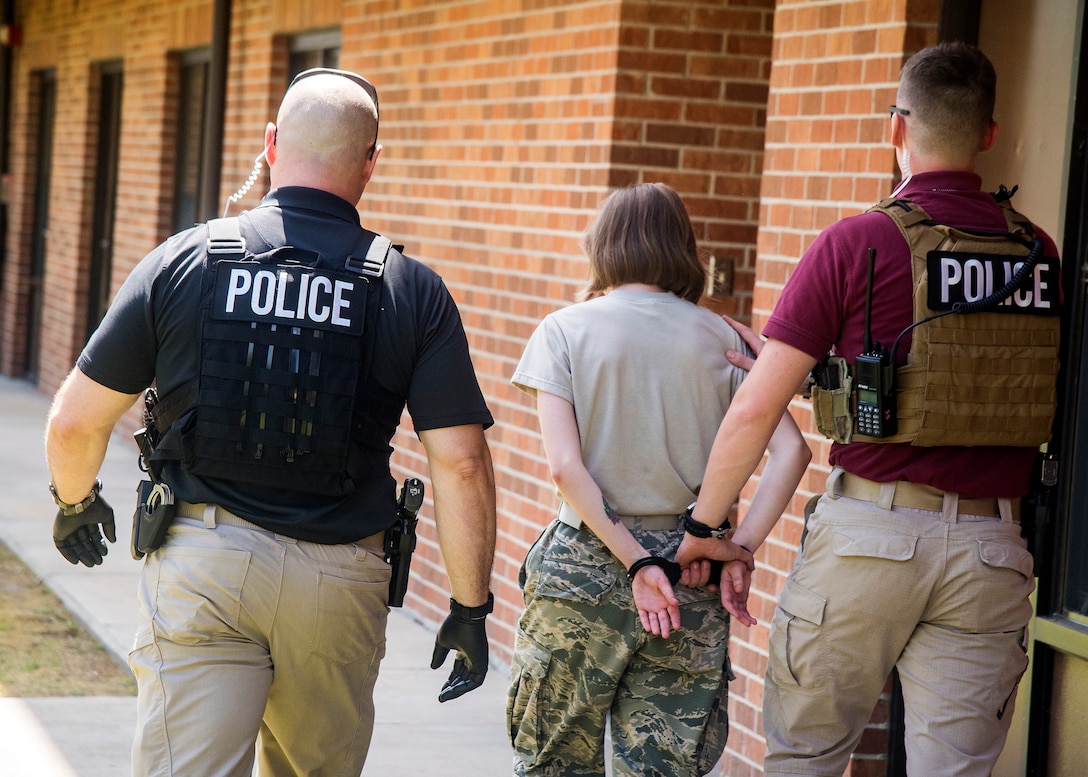 Investigators from the 23d Security Forces Squadron, escort a suspect from a simulated crime scene, June 26, 2019, at Moody Air Force Base, Ga. Security forces investigators are required to respond to incidents and scenarios that require a higher level of attention and sensitivity. After gathering the facts and evidence from a crime scene, investigators will locate, apprehend and interrogate the suspect to determine if a crime was committed. (U.S. Air Force photo by Airman 1st Class Eugene Oliver)