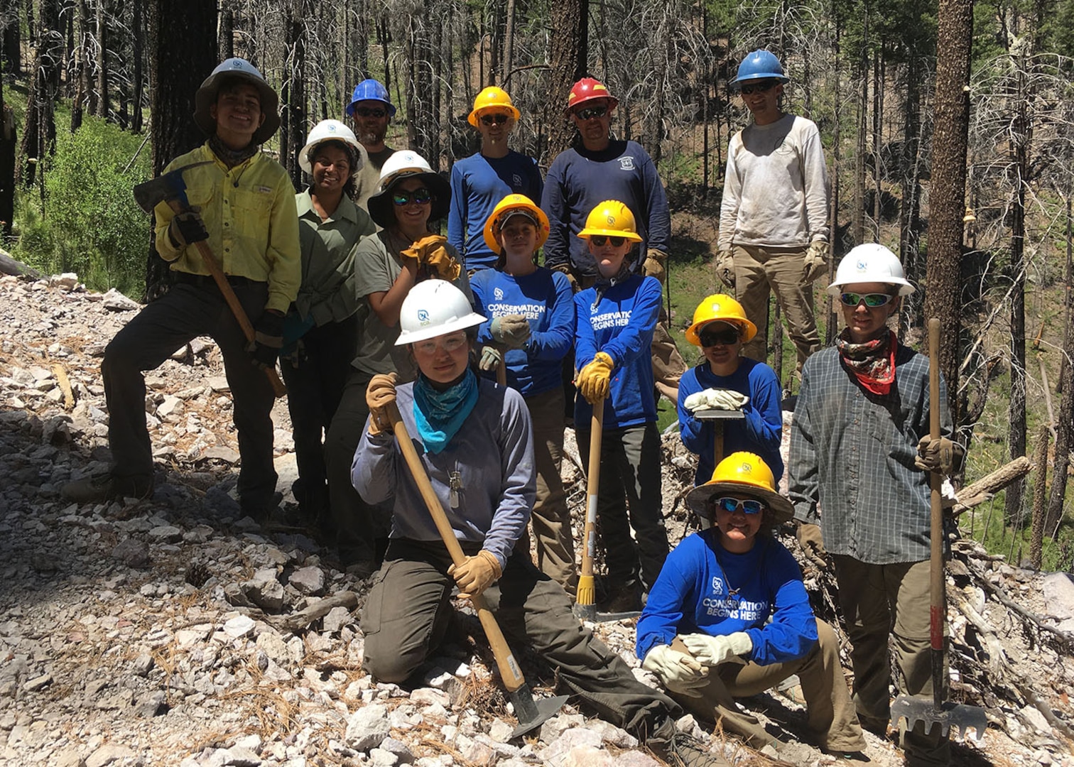 Youth Conservation Corps crew members and US Forest Service staff pose for a group photo in the Coronado National Forest in southern Arizona.