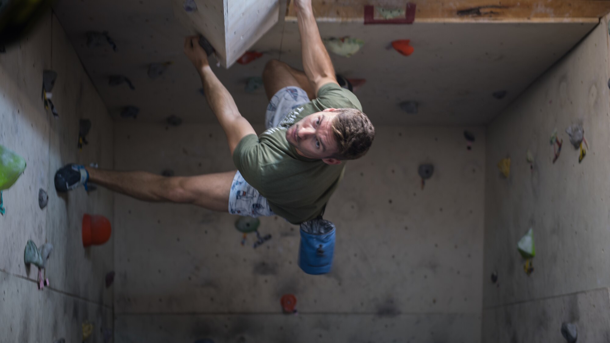 U.S. Air Force 1st Lt. Luke Russell, 386th Expeditionary Medical Group physician’s assistant, climbs the bouldering wall near the Flex Gym on Ali Al Salem Air Base, Kuwait, June 30, 2019. Russell worked with a colleague to renovate and improve the bouldering wall to provide an additional fitness option for ASAB personnel. (U.S. Air Force photo by Tech. Sgt. Daniel Martinez)