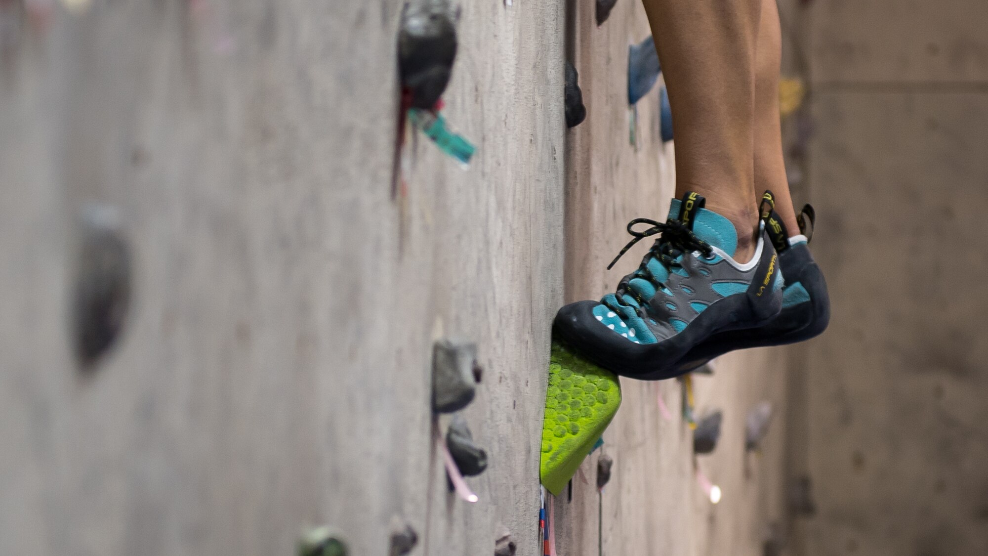 U.S. Air Force Maj. Breanna Gawrys, 386th Expeditionary Medical Group physician, steps onto a climbing hold on the bouldering wall near the Flex Gym on Ali Al Salem Air Base, Kuwait, June 30, 2019. Gawrys worked with a colleague to renovate the wall and provide an additional fitness option for ASAB personnel. (U.S. Air Force photo by Tech. Sgt. Daniel Martinez)
