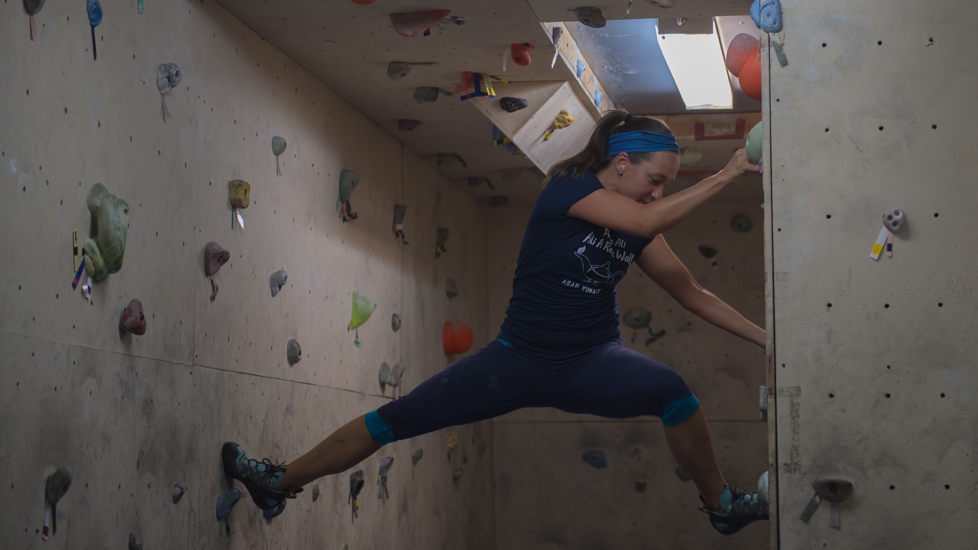 U.S. Air Force Maj. Breanna Gawrys, 386th Expeditionary Medical Group physician, climbs the bouldering wall near the Flex Gym on Ali Al Salem Air Base, Kuwait, June 30, 2019. Gawrys worked with a colleague to renovate the wall and provide an additional fitness option for ASAB personnel. (U.S. Air Force photo by Tech. Sgt. Daniel Martinez)
