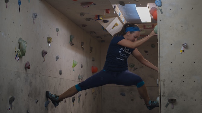 U.S. Air Force Maj. Breanna Gawrys, 386th Expeditionary Medical Group physician, climbs the bouldering wall near the Flex Gym on Ali Al Salem Air Base, Kuwait, June 30, 2019. Gawrys worked with a colleague to renovate the wall and provide an additional fitness option for ASAB personnel. (U.S. Air Force photo by Tech. Sgt. Daniel Martinez)