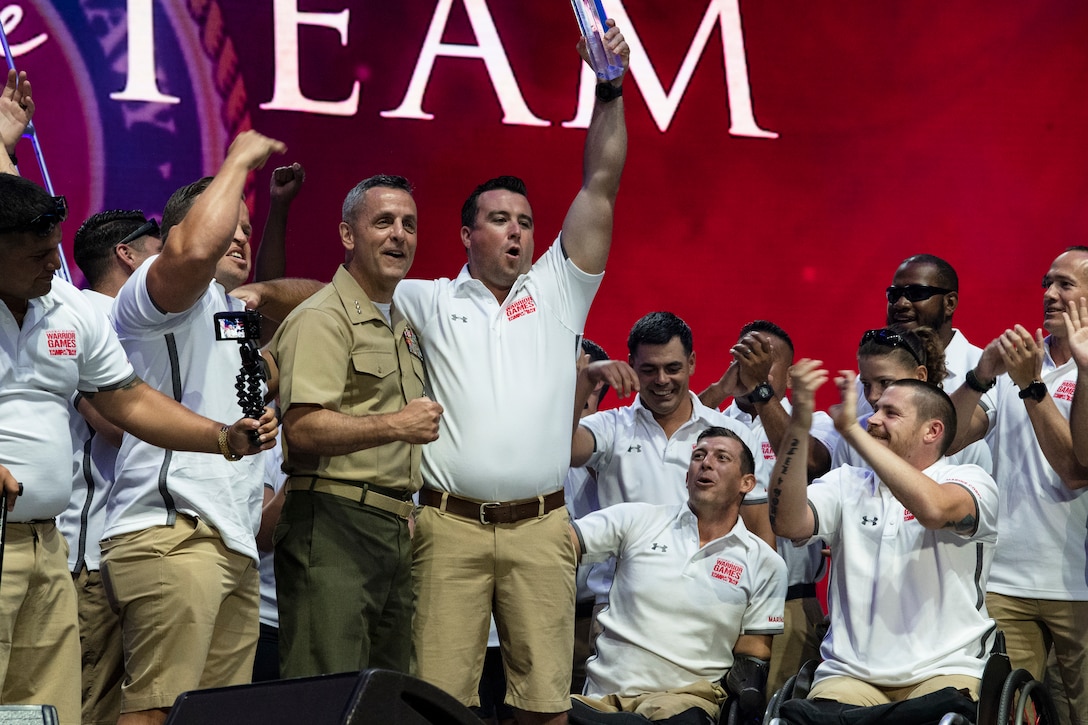 U.S. Marine Corps Gunnery Sgt. Raymond Archer lifts the  “Heart of the Team” award after being presented the award by Lt. Gen. Michael Rocco, Deputy Commandant for Manpower and Reserve Affairs, at the 2019 DoD Warrior Games closing ceremony in Tampa, Florida, June 30. The DoD Warrior Games is an adaptive sports competition for wounded, ill and injured service members and veterans. The Warrior Games showcase the resilient spirit of today’s wounded, ill or injured service members from all branches of the military and provide a venue for recovering service members and veterans to demonstrate triumph over significant physical or invisible wounds and injuries.