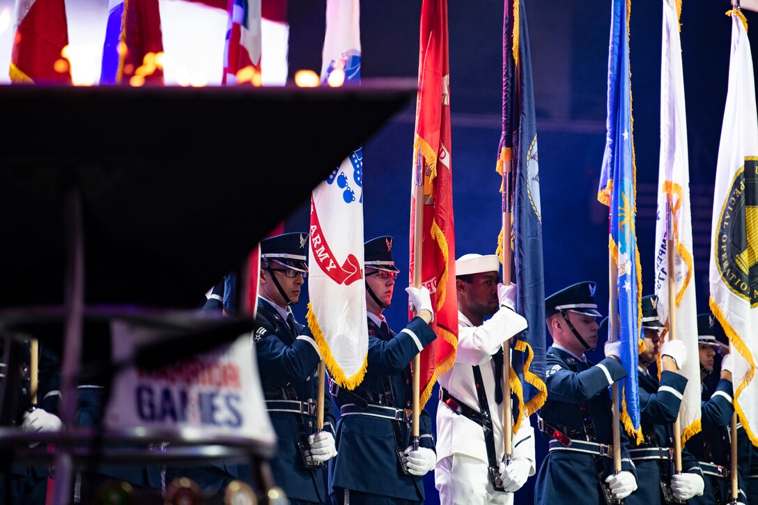 The 2019 DoD Warrior Games color guard marches on stage at the games’ closing ceremony at Amalie Arena, Tampa, Florida, June 30, 2019. The 2019 Warrior Games consist of 13 Paralympic-style sports, and more than 300 athletes representing the U.S. Marine Corps, Army, Navy, Air Force, Special Operations Command, and five international teams.