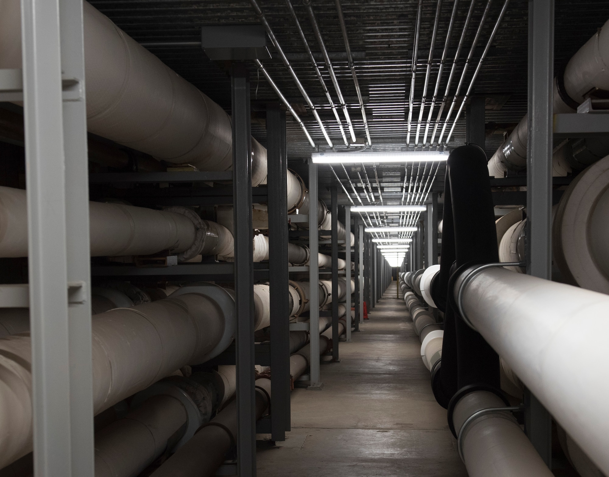 Pipes housing water and other utilities run the length of the David Grant USAF Medical Center basement at Travis Air Force Base, California, June 14, 2019. All of the pipes are stabilized by seismic bracing to ensure the hospital would still be able to function in the event of an earthquake. (U.S. Air Force photo by Staff Sgt. Amber Carter)