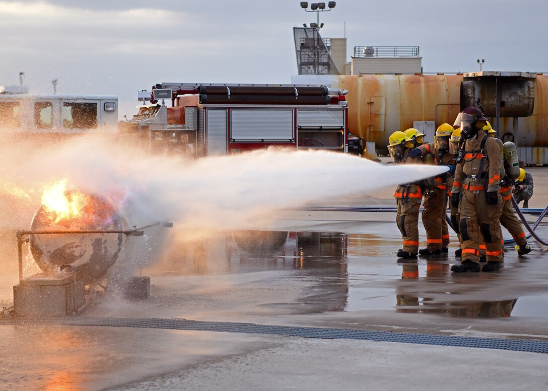 312th Training Squadron students use hands on training to combat a gas fire by spraying the source at the Louis F. Garland Department of Defense Fire Academy on Goodfellow Air Force Base, Texas, June 27, 2019. The students were shown how quickly a gas fire could get out of hand if not properly controlled. (U.S. Air Force photo by Airman 1st Class Ethan Sherwood)
