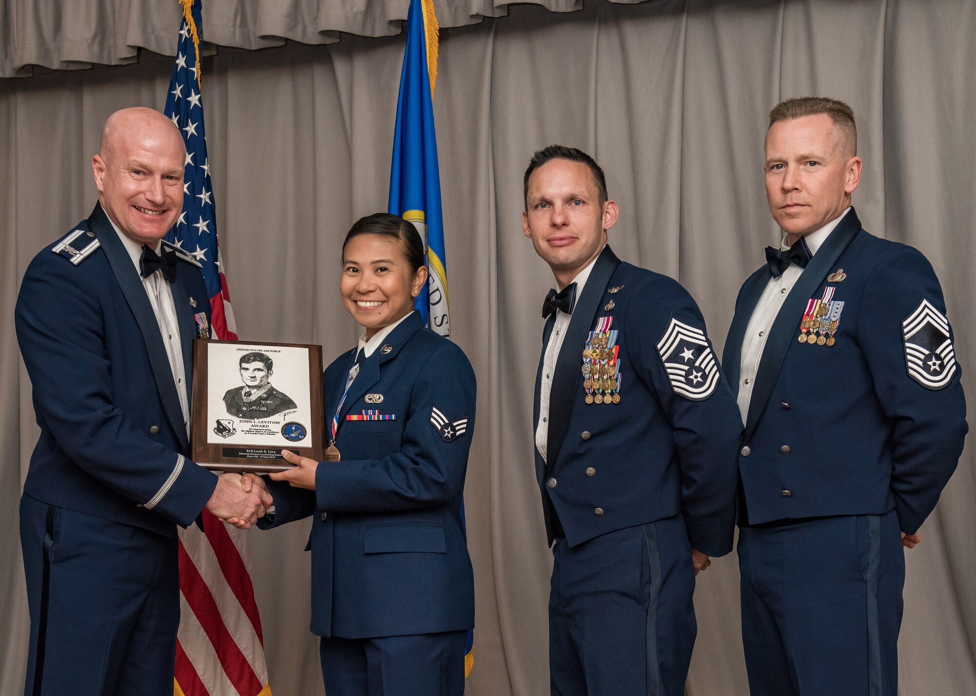 Senior Airman Leah Lira, 452nd Maintenance Squadron, out of March Air Reserve Base, receives the John L. Levitow Award during a graduation ceremony for Airman Leadership Class 19E at Edwards Air Force Base, California, June 27. The Levitow Award is the highest award presented at ALS.(U.S. Air Force photo by Matthew Williams)