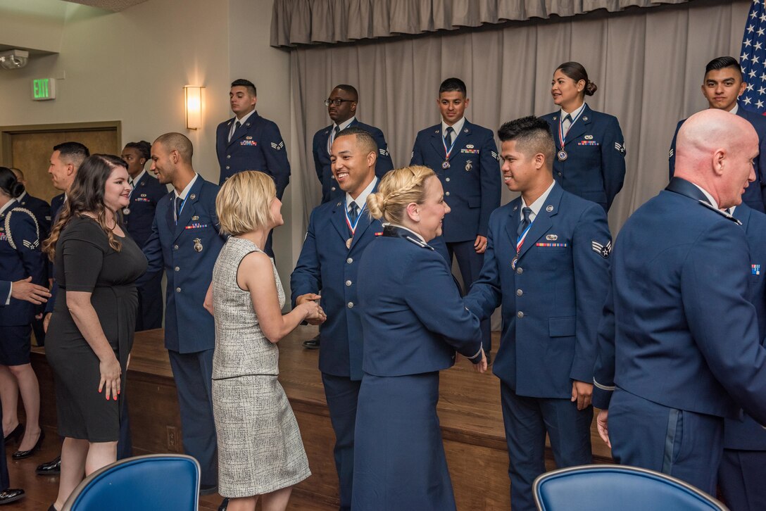 Family, friends and colleagues congratulate members of Airman Leadership School Class 19E at Edwards Air Force Base, California, June 27. (U.S. Air Force photo by Matthew Williams)