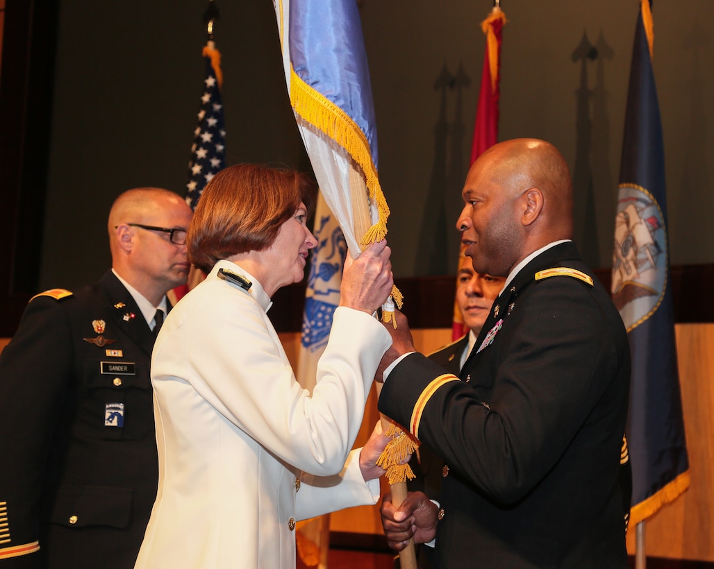 Outgoing Defense Information Systems Agency (DISA) Central Field Command, commander, U.S. Army Col. Corey L. Brumsey, passes the command flag to director, DISA and Commander, Joint Force Headquarters – Department of Defense Information Network, U.S. Navy Vice Adm. Nancy A. Norton, during a change of command ceremony at U.S. Central Command Headquarters, June 28, 2019. DISA provides, operates and defends the DoD Information Network in the Central Region area of responsibility; maintains situational awareness, and supports integrated planning to assure enterprise capabilities in support of U.S. Central Command and mission partners. (U.S. Central Command Public Affairs photo by Tom Gagnier)