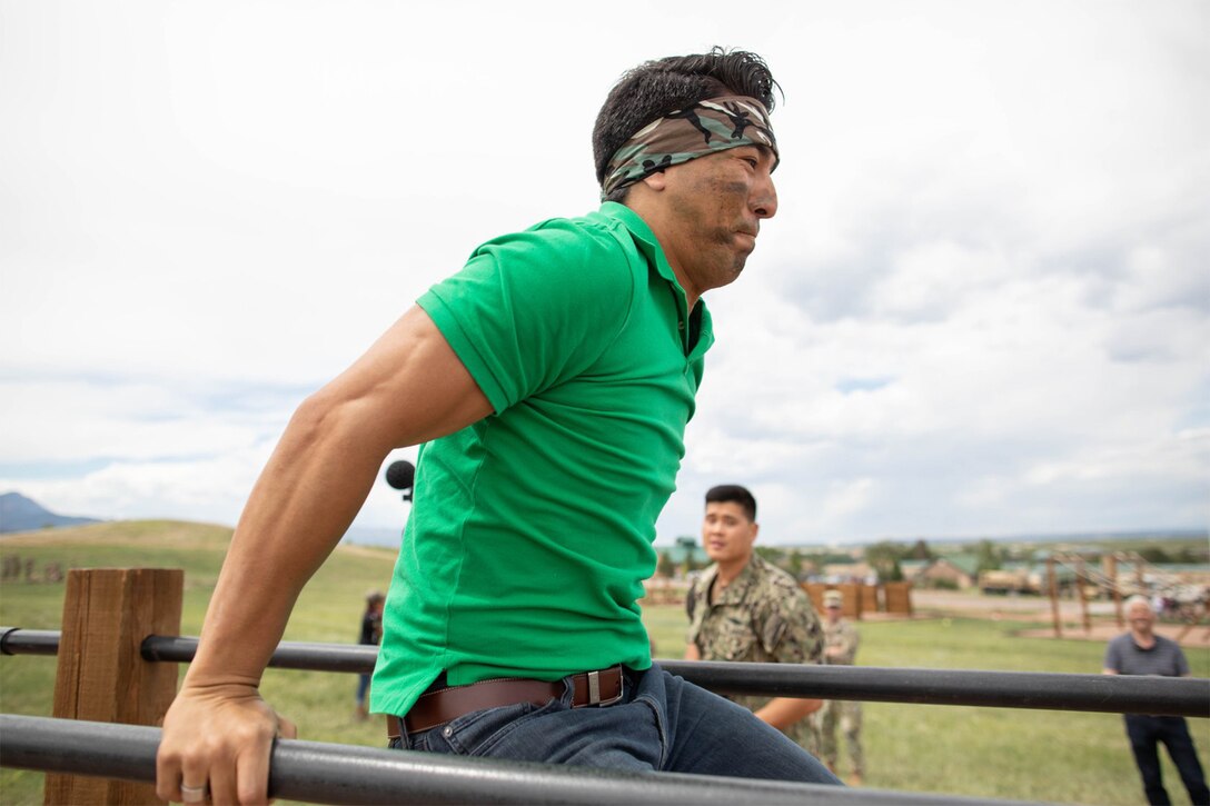 A civilian tackles the obstacle course.