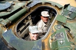 U.S. Air Force Staff Sgt. Hannah Fell, 140th Wing Medical Group, is shown the inside of a Jordan Armed Forces-Arab Army tank by an instructor with the Royal Jordanian Air Force. Members of the Colorado Air National Guard spent the day touring King Abdullah II Air Base and its ground defense equipment in Az Zarga, Jordan, April 16, 2019. The meeting between Jordanians and senior enlisted leaders aimed to foster strong relationships between forces as well as enhance Jordanian enlisted policy and practices. Jordan and Colorado have been partners through the National Guard State Partnership Program since 2004. (U.S. Air National Guard photo by Tech. Sgt. Chance Johnson)