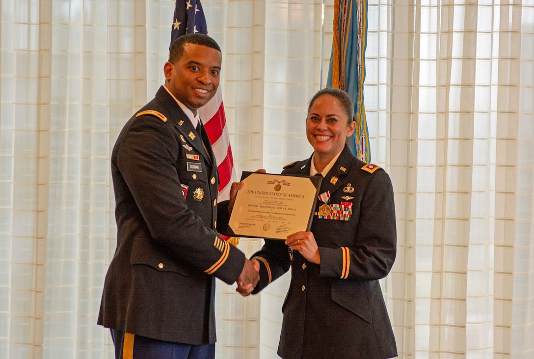 Army Col. Kevin Cotman presented Army Lt. Col. Josielyn Carrasquillo with the Defense Meritorious Service Medal