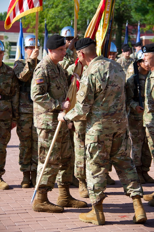 Lt. Gen. Terry R. Ferrell, commanding general, U.S. Army Central, passes the colors to Maj. Gen. John P. Sullivan, incoming commanding general, 1st Theater Sustainment Command (TSC), during a change of command ceremony held July 2, 2019 outside Fowler Hall at Fort Knox, Ky.
