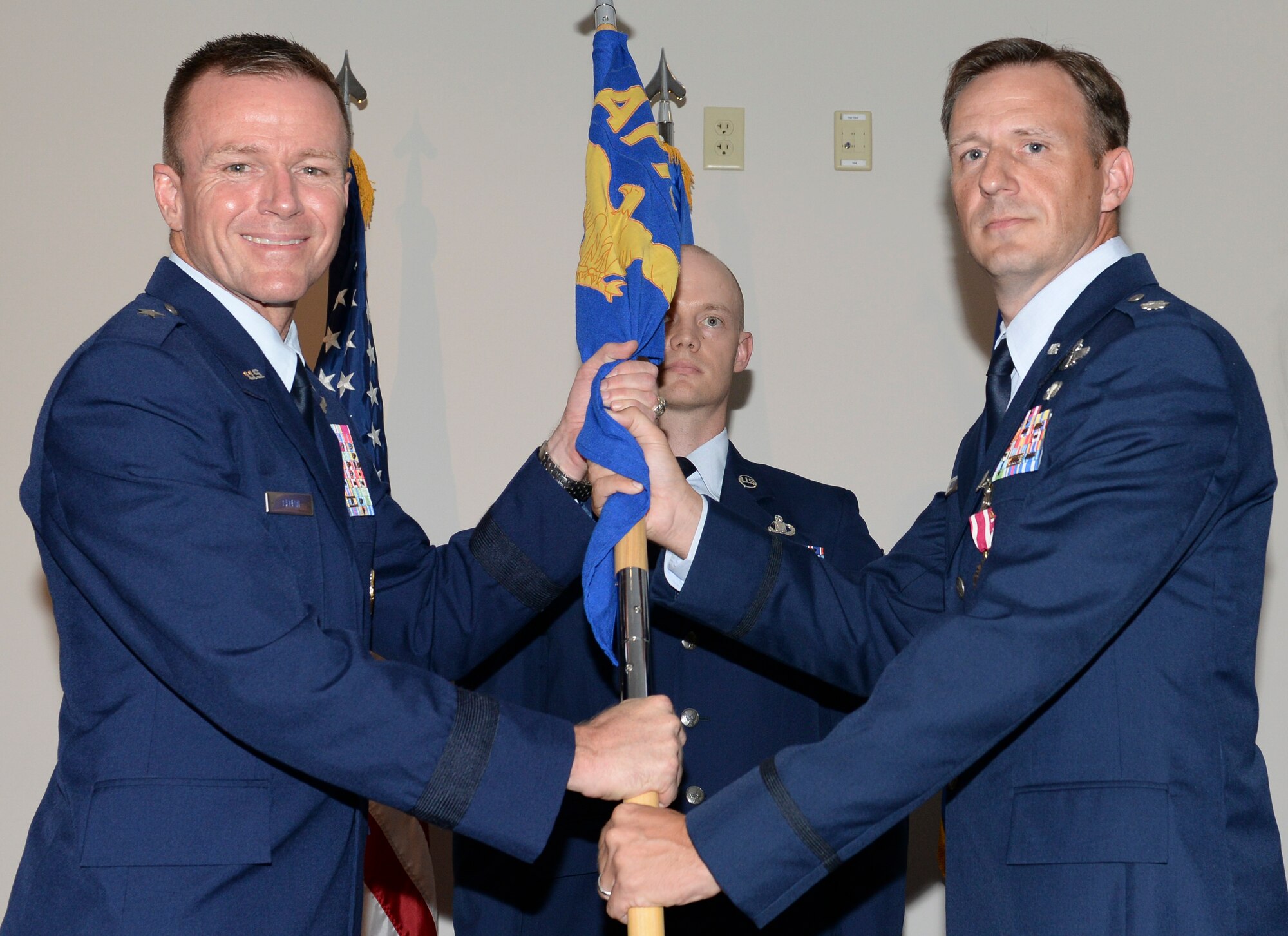 U.S. Air Force Lt. Col. Evan H. Gardner, outgoing commander, Air Force Rescue Coordination Center relinquishes the AFRCC guidon to Brig. Gen. Kenneth P. Ekman, vice commander, 1 AF (Air Forces Northern), during a change of command ceremony July 2, 2019, Tyndall AFB, Fla.