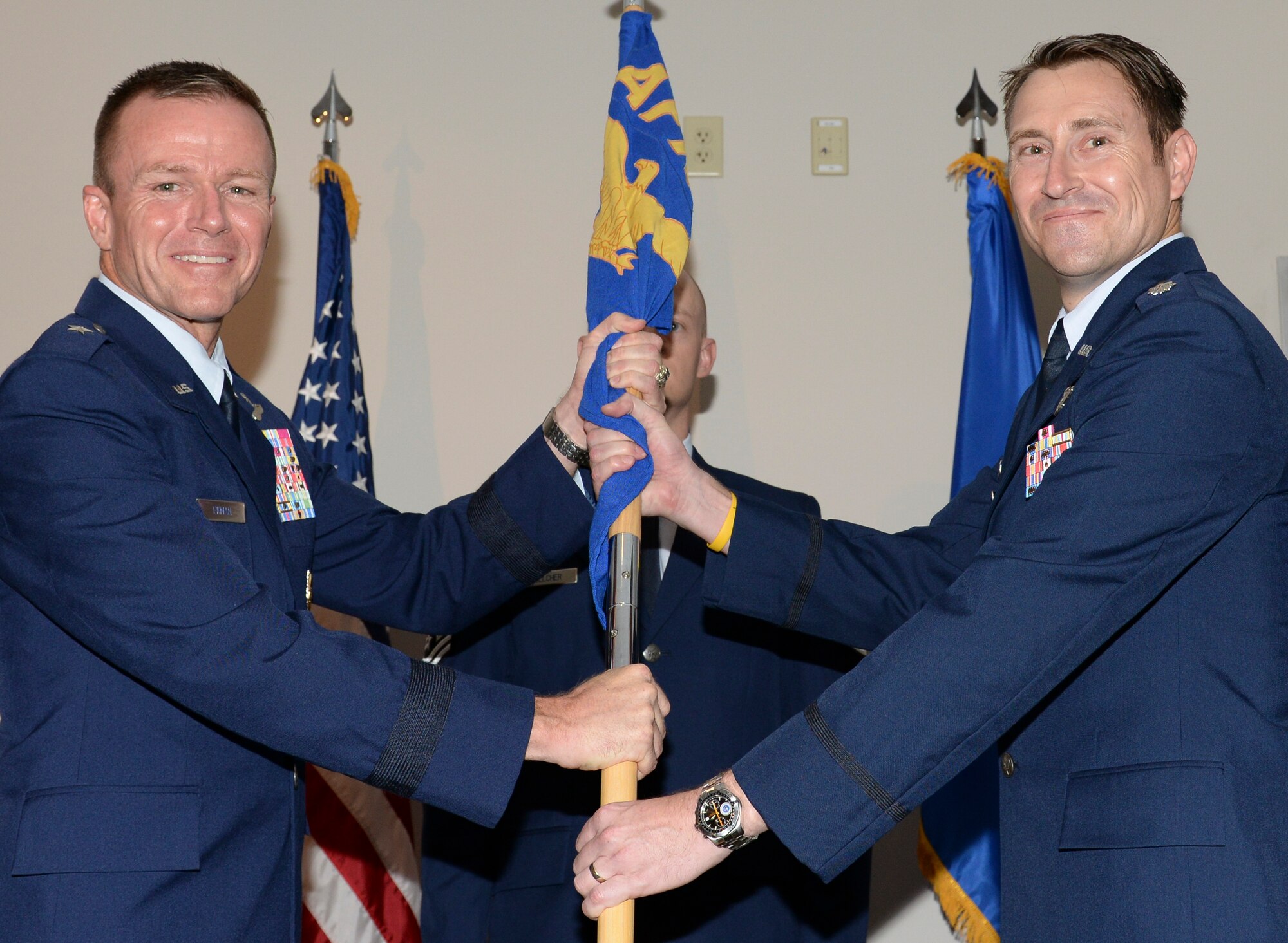 U.S. Air Force Lt. Col. Gene M. Manner, commander, Air Force Rescue Coordination Center accepts the AFRCC guidon from Brig. Gen. Kenneth P. Ekman, vice commander, 1 AF (Air Forces Northern), during a change of command ceremony July 2, 2019, Tyndall AFB, Fla.