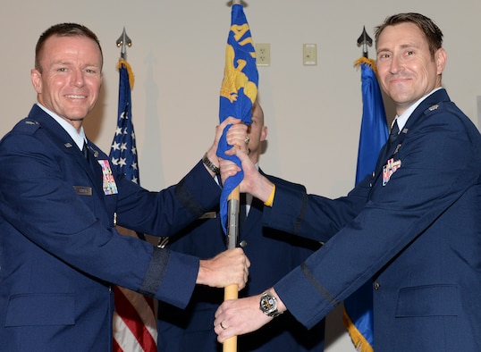 U.S. Air Force Lt. Col. Gene M. Manner, commander, Air Force Rescue Coordination Center accepts the AFRCC guidon from Brig. Gen. Kenneth P. Ekman, vice commander, 1 AF (Air Forces Northern), during a change of command ceremony July 2, 2019, Tyndall AFB, Fla.