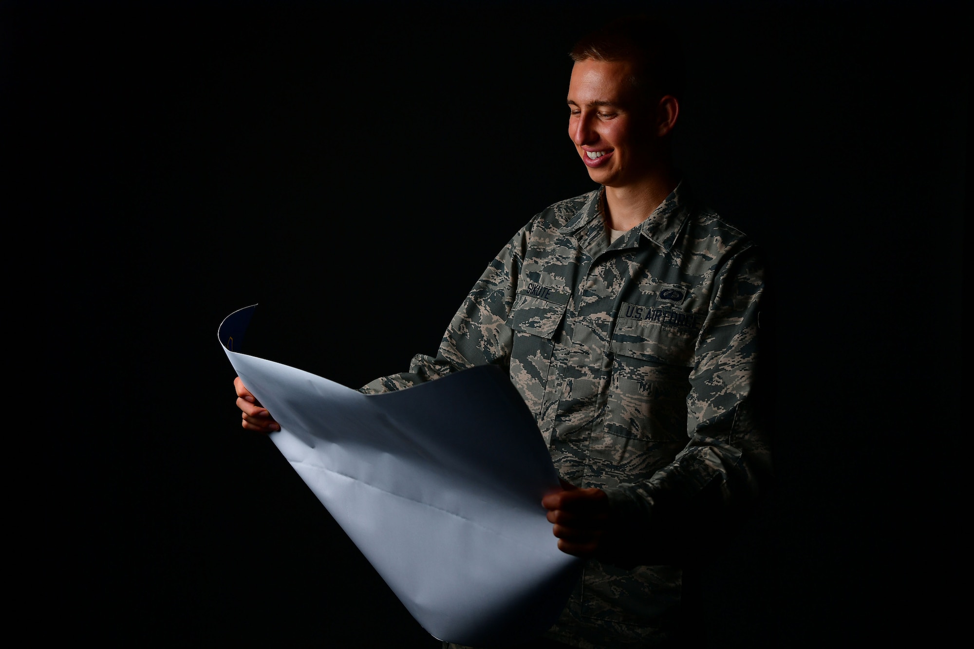 An Airman poses for a photo in the studio.