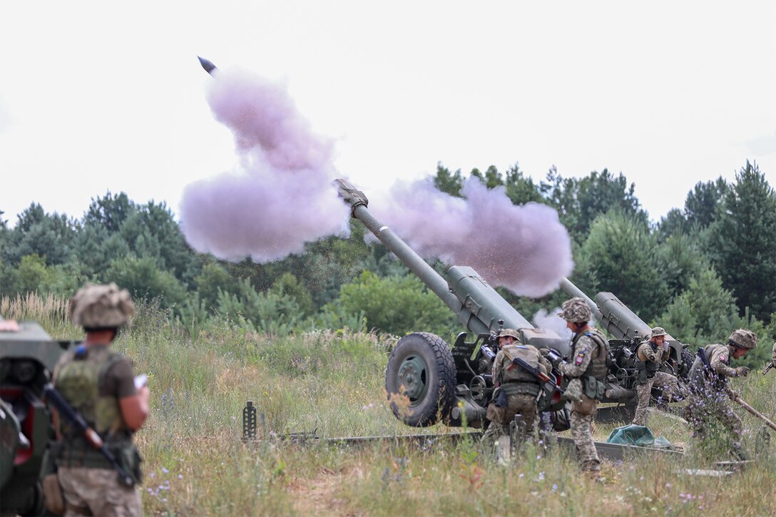 Soldiers fire a weapon during training.