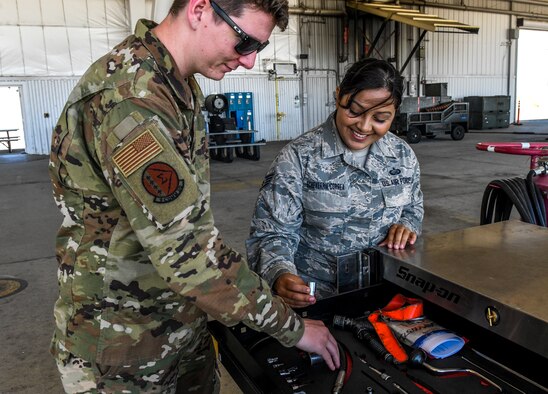 Airman 1st Class Nicholas Morris, 9th Communication Squadron mission defense team technician, and Staff Sgt. Stephanie Echeverria-Correa, 9th Force Support Squadron NCOIC of customer support, fix the tools in the tool box on the flightline at Beale Air Force Base, Calif., June 26, 2019. During the Maintance For A Day experience, Morris and Echeverria-Correa were able to get hands on experience with different sections and various jobs on the flightline. (U.S. Air Force Photo by Senior Airman Colville McFee)