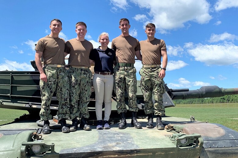 Program Executive Officer Land Systems introduced midshipmen from the U.S. Naval Academy, pictured on an M1A1 Abrams tank in June 2019, to the military acquisition process through the summer PEO LS Internship Program. The program was established in 2013 as a way to introduce cadets and midshipmen from the U.S. Military Academy and USNA to the world of Marine Corps acquisition. (Courtesy photo)