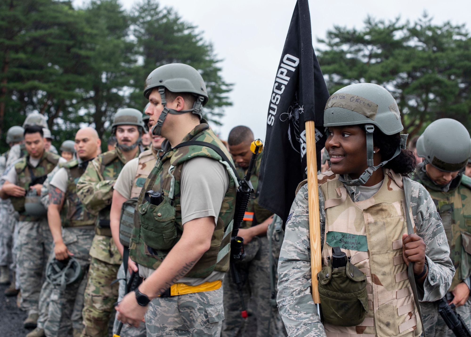 U.S. Air Force Airman 1st Class Shawntia Green, a 35th Logistics Readiness Squadron logistics planner, holds their unit’s squadron flag in formation at Misawa Air Base, Japan, June 28, 2019. Green, along with roughly 75 members throughout LRS joined forces to participate in an agile combat employment exercise. They linked up with the 35th Medical Group and the 35th Security Forces Squadron, who created realistic scenarios for personnel, enhancing their self-aid buddy care skills and introduce proper building clearance procedures. (U.S. Air Force photo by Staff Sgt. Brittany A. Chase)