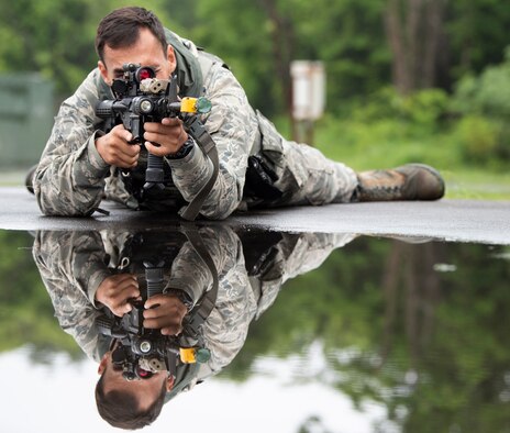 U.S. Air Force Senior Airman Dylan White, a 35th Security Forces Squadron military working dog handler, lays in the “prone” position during an agile combat employment exercise at Misawa Air Base, Japan, June 28, 2019. White taught 35th Logistic Readiness Squadron how to move, shoot and communicate and applied their newly learned skills to realistic training scenarios, such as clearing buildings and shooting techniques during ACE. (U.S. Air Force photo by Staff Sgt. Brittany A. Chase)