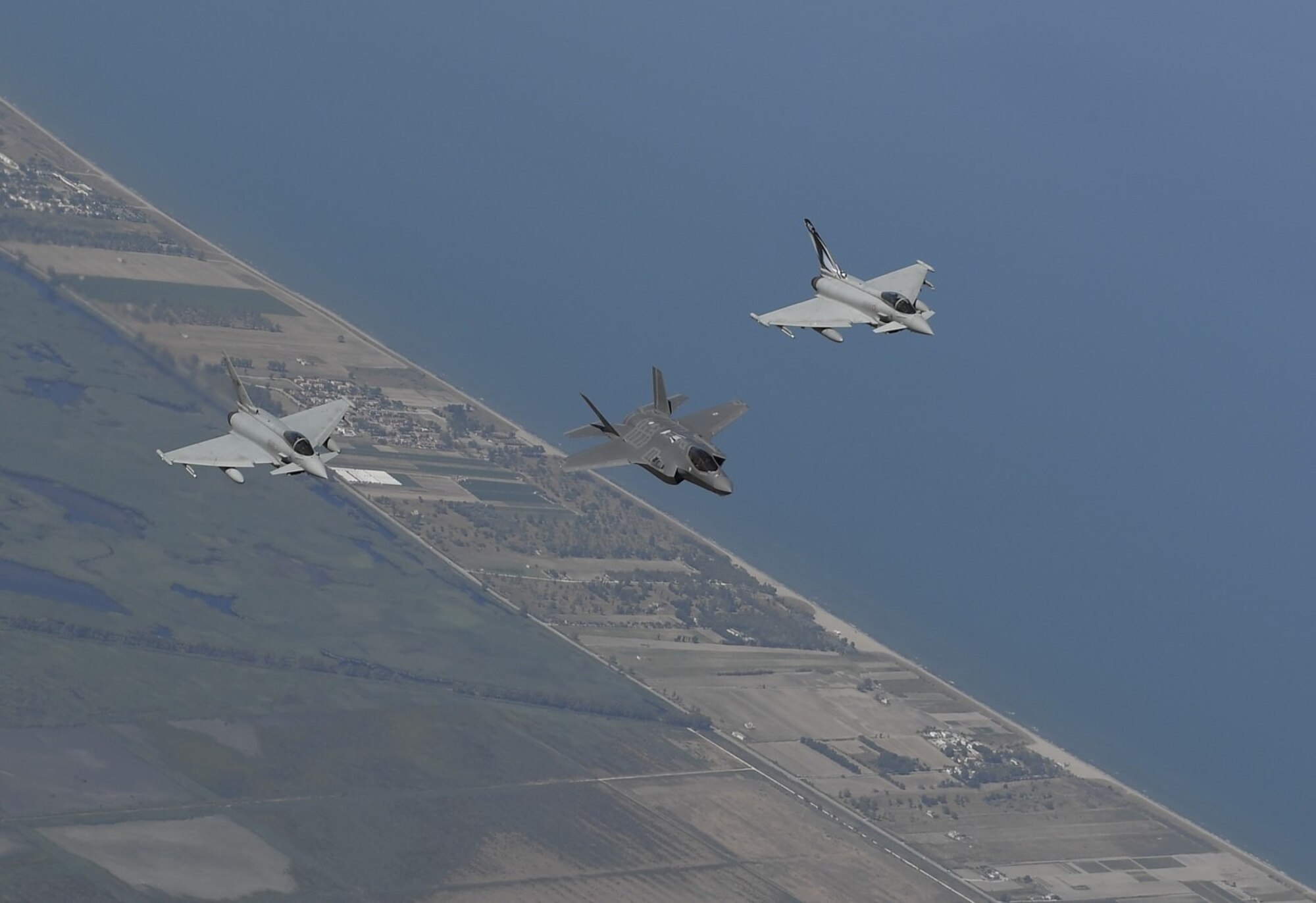 Italian air force F-35 and Eurofighter Typhoons fly in formation over Italy during a training mission with U.S. Air Force F-35A Lightning II aircraft, July 2, 2019. F-35s possess a unique combination of stealth, speed, agility, and situational awareness along with lethal long-range, air-to-air and air-to-ground weaponry, making these aircraft the best air dominance fighters in the world. (Courtesy photo)