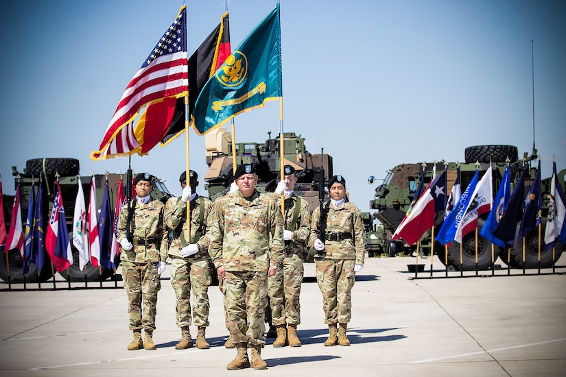 Lt. Col. Jason Knapp, incoming commander, Army Field Support Battalion- Mannheim, signs on as commander, in front of the battalion’s color guard, during a change of command ceremony on Coleman Worksite in Mannheim, Germany, July 2