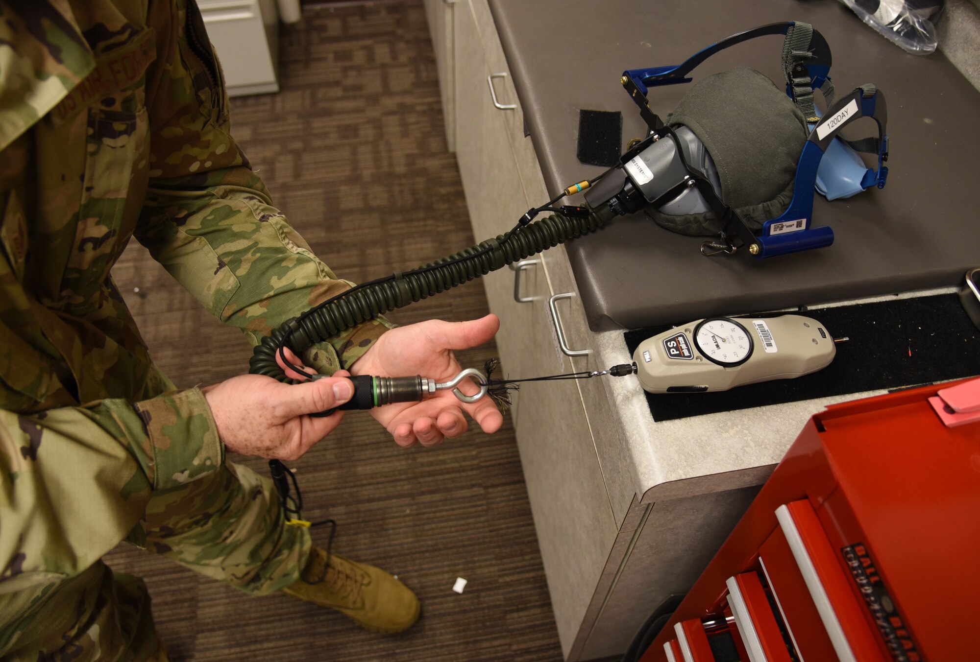 Tech. Sgt. Ronald Patton, 403rd Operation Support Squadron aircrew flight equipment craftsman, conducts a pull disconnect test on the air hoses on the recently received new anti-smoke goggles for the C-130J Super Hercules aircraft, which are replacing the current system that has been used for more than 20 years at Keesler Air Force Base, Mississippi. The new ASGs are an easier quick don system, that now has the eye piece and nose/mouth cover as one single piece, similar to those used by firefighters, and will be in place on the aircraft by the middle of August 2019. (U.S. Air Force photo by Jessica L. Kendziorek)