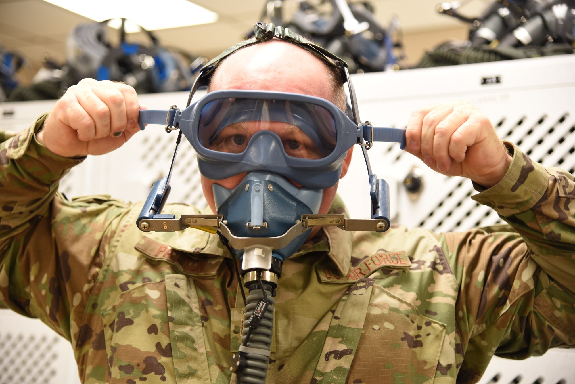 Tech. Sgt. Ronald Patton, 403rd Operation Support Squadron aircrew flight equipment craftsman, demonstrates how to put on the old anti-smoke goggles that has been used for more than 20 years at Keesler Air Force Base, Mississippi. The new ASGs are an easier quick don system, that now has the eye piece and nose/mouth cover as one single piece, similar to those used by firefighters, and will be in place on the aircraft by the middle of August 2019. (U.S. Air Force photo by Jessica L. Kendziorek)