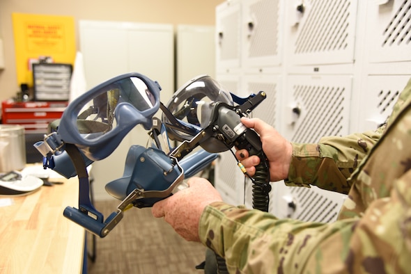 Tech. Sgt. Ronald Patton, 403rd Operation Support Squadron aircrew flight equipment craftsman, shows the difference between the current anti-smoke goggles and the new anti-smoke goggles for the C-130J Super Hercules aircraft, which are replacing the current system that has been used for more than 20 years at Keesler Air Force Base, Mississippi. The new ASGs are an easier quick don system, that now has the eye piece and nose/mouth cover as one single piece, similar to those used by firefighters, and will be in place on the aircraft by the middle of August 2019. (U.S. Air Force photo by Jessica L. Kendziorek)