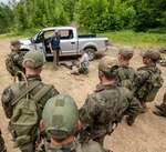 Members of the Polish Territorial Defense Forces receive training in checkpoint vehicle clearing techniques from members of West Virginia Army National Guard (WVARNG) Special Forces during Ridge Runner 19-02, June 24, 2019, in West Virginia. Ridge Runner is a WVARNG training program that provides various National Guard, active duty, and North Atlantic Treaty Organization (NATO) ally nation armed forces with training in irregular and asymmetrical warfare tactics and operations. (U.S. Army National Guard photo illustration by Edwin Wriston.) (This photo has been altered for security purposes by blurring out faces.)