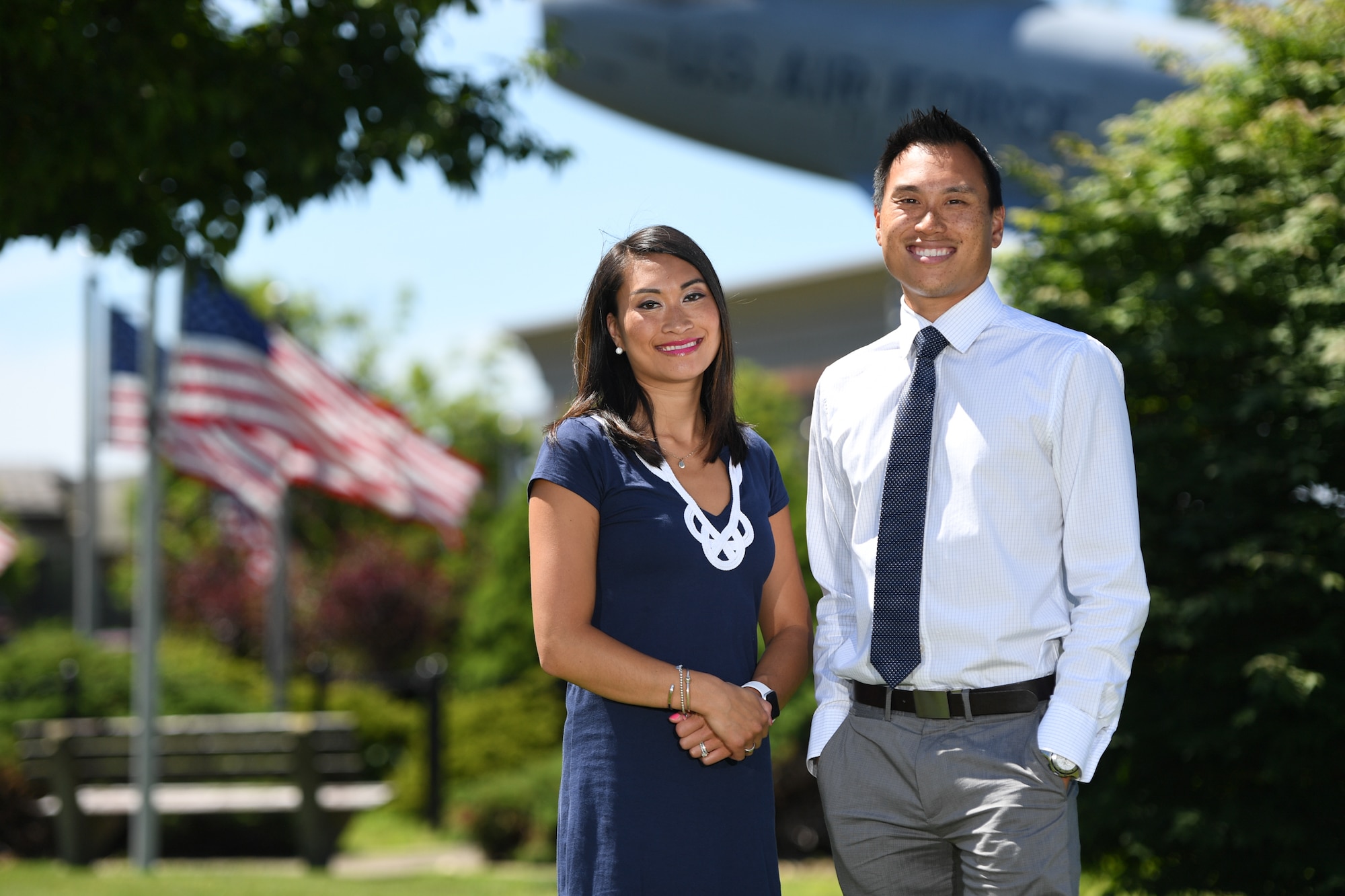 Tiffany Cote and Chris Lung pose for a photo near the F-86 Sabre static display on Hanscom Air Force Base, July 2. Both siblings are assigned to the same office on base where they hire acquisition professionals, and provide guidance on the federal acquisition process. Cote and Lung remember their father driving them by the F-86 when he was an engineer on base. The siblings have followed their parents footsteps into civil service. (U.S. Air Force photo by Mark Herlihy).