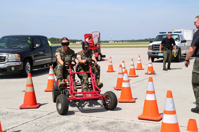 U.S. Marines participate in a simulated drunk driving exercise during the 2019 Fourth of July ‘Booze it & Lose it’ event, code-named Operation Firecracker on Marine Corps Air Station New River, July 1, 2019. The event featured speakers from the air station and local law enforcement. The goal of the event was to eliminate preventable loss of life on North Carolina roadways by discouraging driving while impaired and encouraging the public to use other safe options like ride sharing and commercial transportation. This is the first time the event has been held at Marine Corps Air Station New River, which was chosen to be the backdrop due to the large concentration of young male adults who are considered to be the most at-risk age group. (U.S. Marine Corps photo by Sgt. Jonathan Sosner)