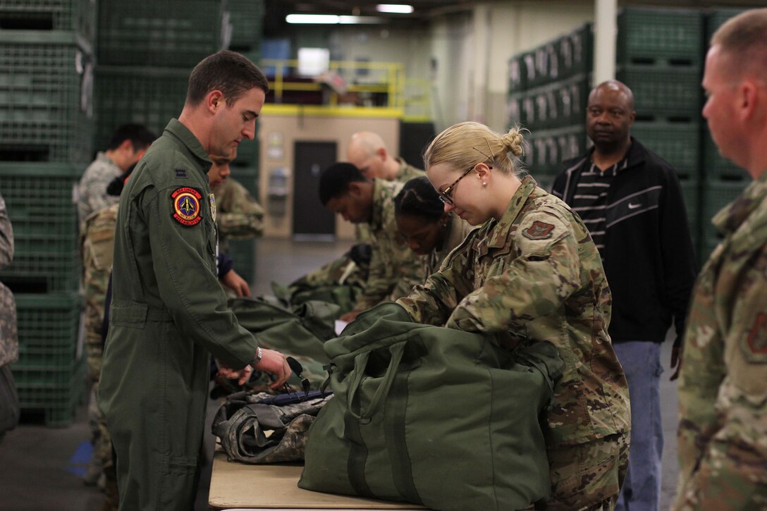 Senior Airman Casey Schlotman, material management journeyman with the 445th Logistics Readiness Squadron, assists a captain from the 60th Logistics Readiness Squadron with recovering and processing mobility gear at Travis Air Force Base, Calif. Twenty two Reserve Citizen Airmen from the 445th LRS performed their annual tour at Travis AFB May 7-23, 2019.