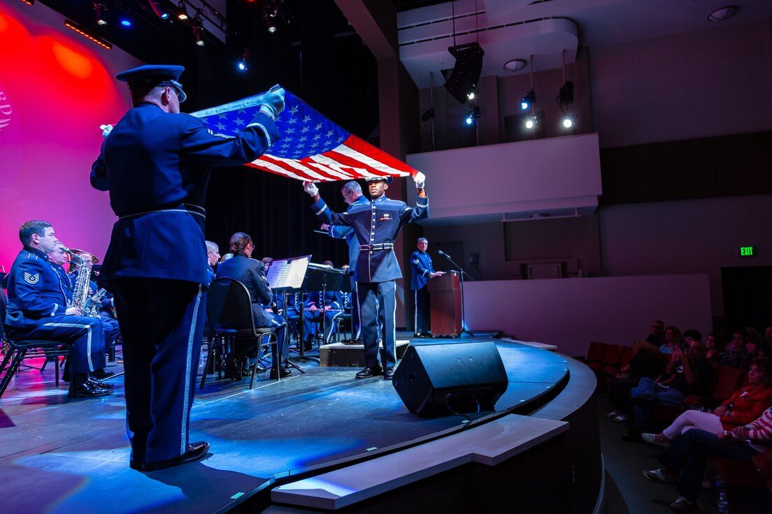 Senior Master Sergeant Steve Burdick and Staff Sergeant Tony Watson begin a flag folding ceremony during a 2018 performance by the ANG Band of the South's Concert Band.