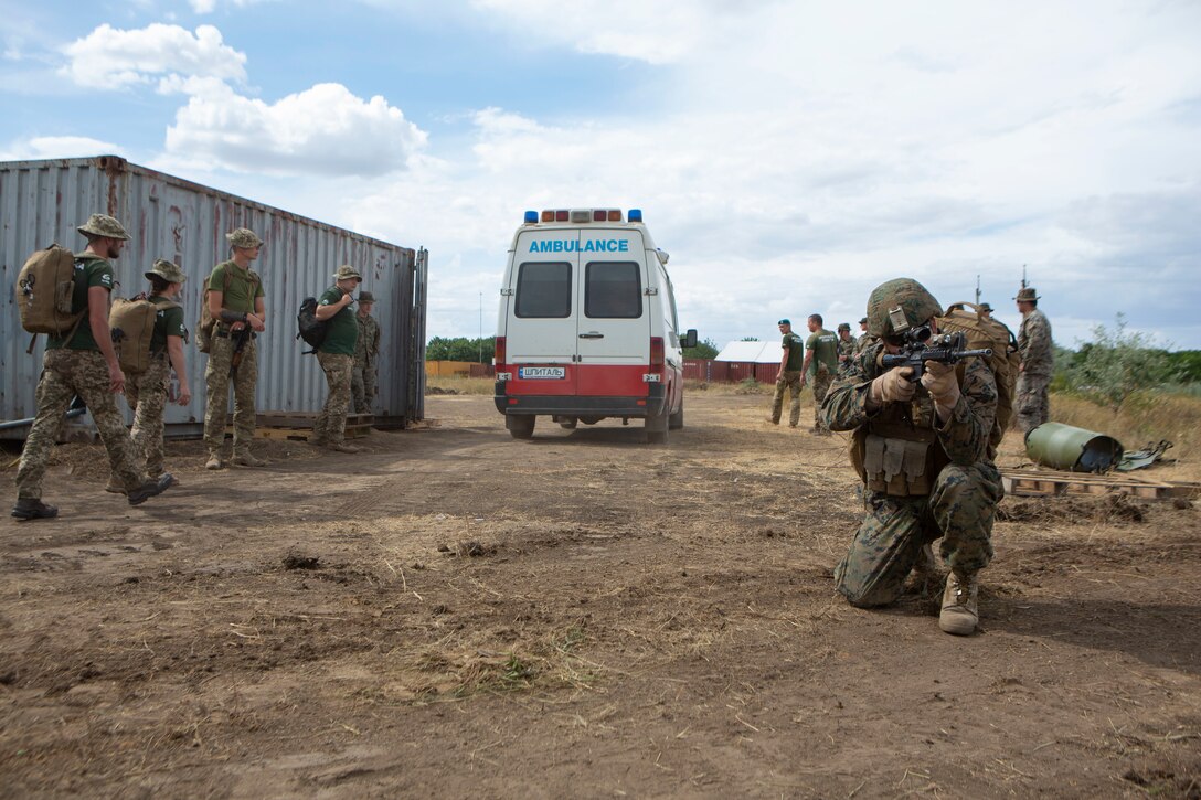A U.S. Navy Sailor with Marine Rotational Force-Europe 19.2, Marine Forces Europe and Africa, posts security for a simulated casualty evacuation during Sea Breeze 19 in Chabanka, Ukraine, June 29, 2019. Sea Breeze is a U.S. and Ukraine co-hosted multinational maritime exercise held in the Black Sea and is designed to enhance interoperability of participating nations and strengthen maritime security and peace within our region. (U.S. Marine Corps photo by Sgt. Williams Quinteros)