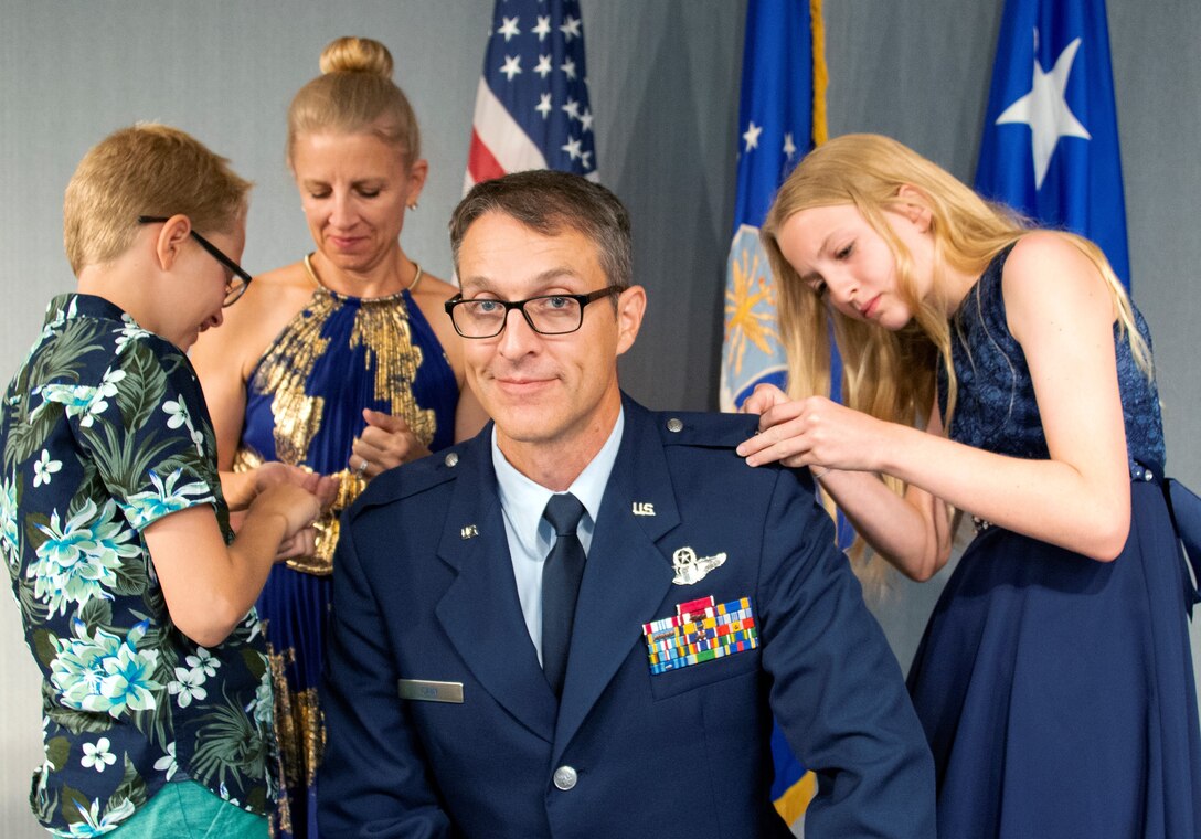 Col Scott A. Cain’s family pin general officer stars to his uniform during his promotion ceremony July 2 at Eglin Air Force Base, Fla. Cain was promoted to the rank of brigadier general prior to taking command of the 96th Test Wing at a later ceremony that day. (U.S. Air Force Photo/Heather Stacy)