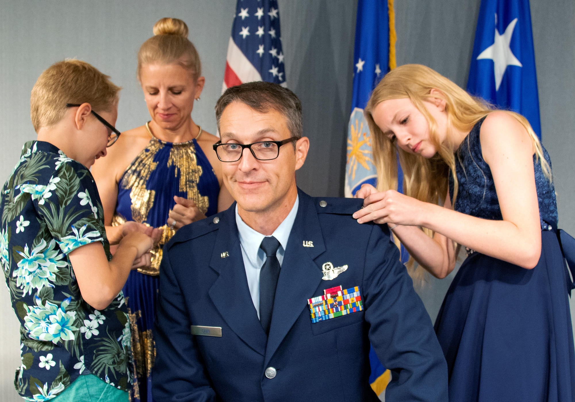 Col Scott A. Cain’s family pin general officer stars to his uniform during his promotion ceremony July 2 at Eglin Air Force Base, Fla. Cain was promoted to the rank of brigadier general prior to taking command of the 96th Test Wing at a later ceremony that day. (U.S. Air Force Photo/Heather Stacy)