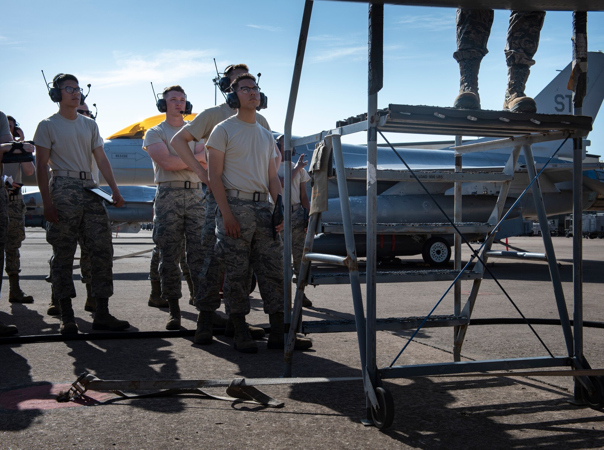 362nd Training Squadron F-16 crew chief apprentice course students stand in line at Sheppard Air Force Base, Texas, July 2, 2019. The students are waiting their turn to see their instructor in the F-16's flightdeck, who will show them the lights operations check checklist and show how the flightdeck works. (U.S. Air Force photo by Airman 1st Class Pedro Tenorio)