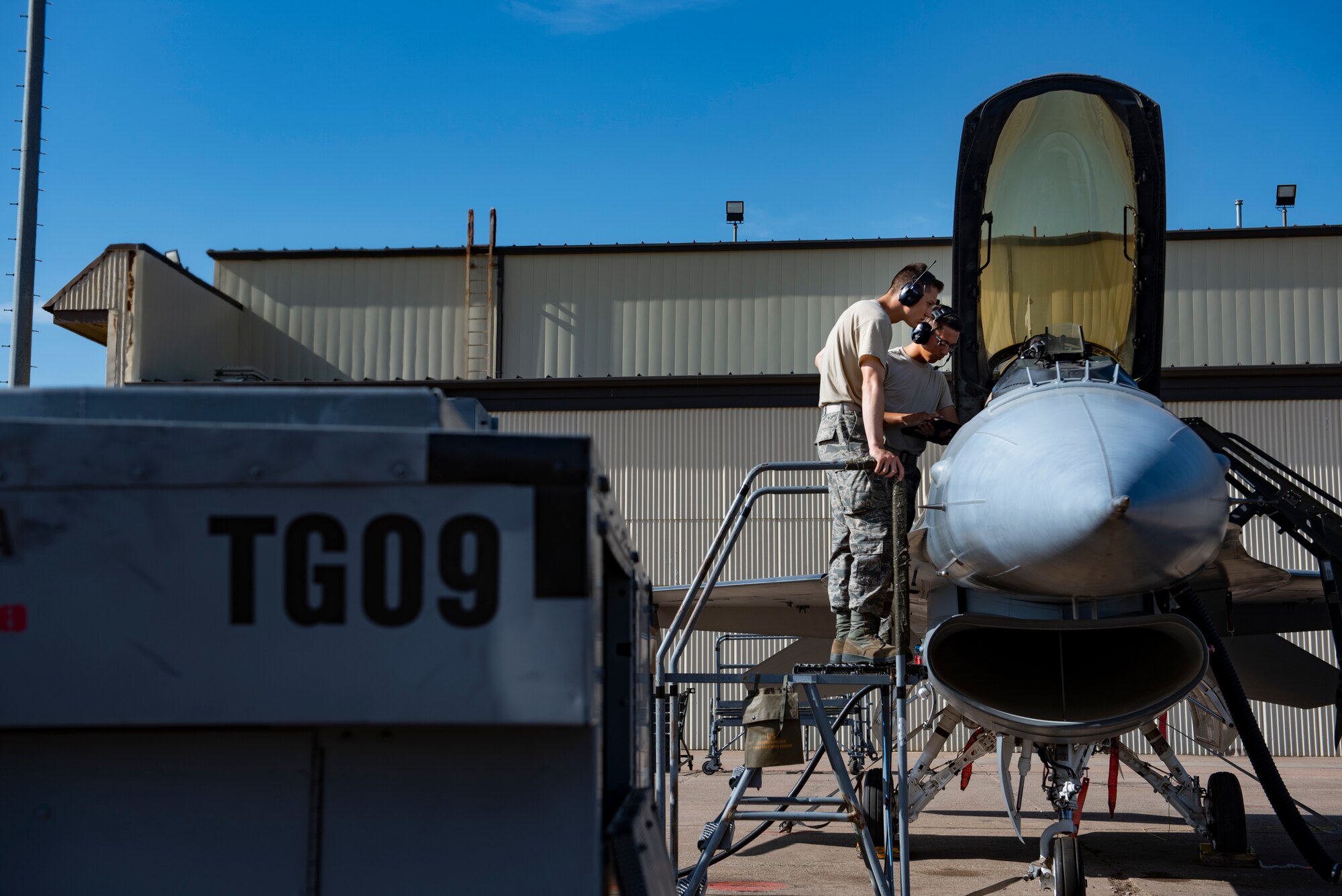 362nd Training Squadron F-16 crew chief apprentice course students look into an F-16 Fighting Falcon's flightdeck at Sheppard Air Force Base, Texas, July 2, 2019. The students are performing a lights operations check and are learning which switch controls what light. (U.S. Air Force photo by Airman 1st Class Pedro Tenorio)