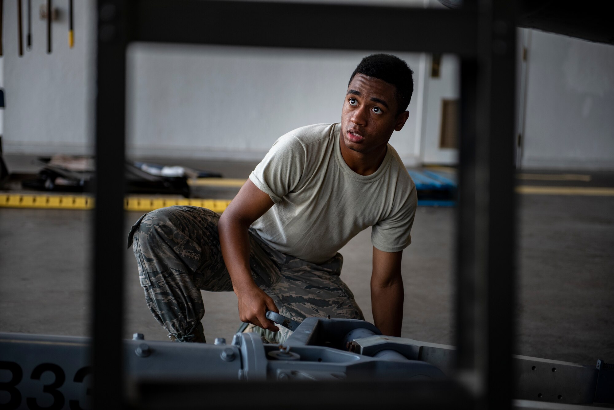 Airman Anthony Washington, 362nd Training Squadron F-16 crew chief apprentice course student, connects a tow bar at Sheppard Air Force Base, Texas, July 2, 2019. Washington enjoys being able to work on aircraft, especially the F-16 Fighting Falcon as he thinks it is the second best plane, right behind the A-10 Warthog. (U.S. Air Force photo by Airman 1st Class Pedro Tenorio)