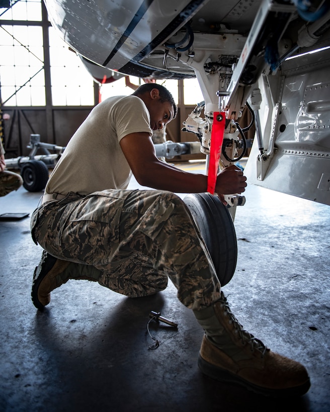 Airman Anthony Washington, 362nd Training Squadron F-16 crew chief apprentice course student, tries to connects the torque links on the front landing gear at Sheppard Air Force Base, Texas, July 2, 2019. Torque links when disconnected allows the wheel to move around more freely, they are connected before flight though as a free wheel moving in multiple directions would not be the best for landing. (U.S. Air Force photo by Airman 1st Class Pedro Tenorio)