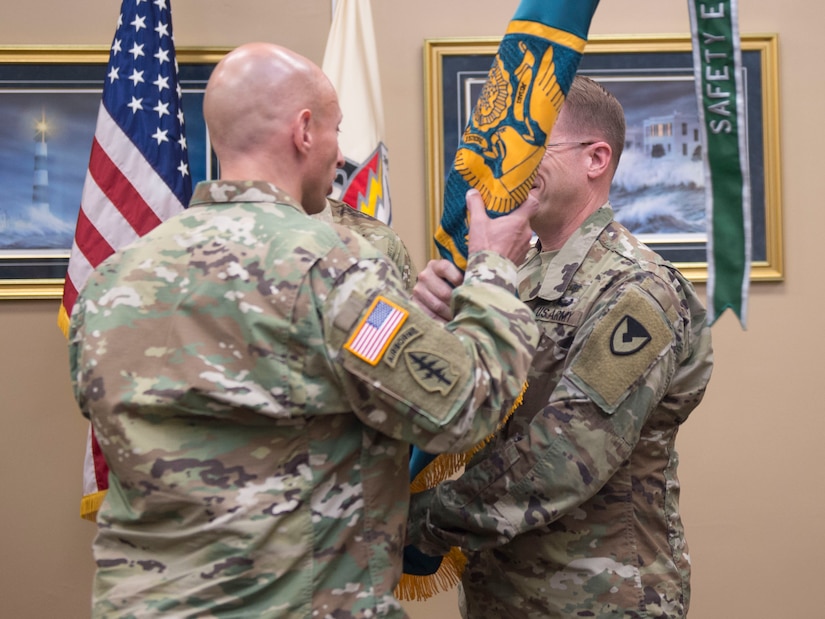 Lt. Col. Kenneth Hoisington, outgoing commander of the Army Field Support Battalion (ASFBn) Charleston, passes the AFSBn Charleston colors to Col. Michael Rivera, commander of the 404th Army Field Support Brigade, Joint Base Lewis-McChord, Wash., during a change of command ceremony at the Joint Base Charleston Naval Weapons Station, S.C., July 2, 2019. AFSBn Charleston is responsible for providing worldwide contingency sustainment support and provides U.S. Army combat power by establishing, maintaining and reconstituting Army Prepositioned Stocks Afloat and Southern Command activity sets.