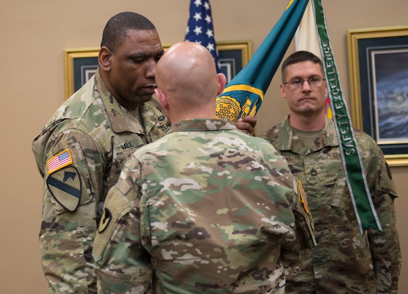 Col. Michael Rivera, commander of the 404th Army Field Support Brigade, Joint Base Lewis-McChord, Wash., passes the Army Field Support Battalion (ASFBn) Charleston colors to Lt. Col. Dion Hall, incoming commander of the ASFBn Charleston, during a change of command ceremony at the Joint Base Charleston Naval Weapons Station, S.C., July 2, 2019. AFSBn Charleston is responsible for providing worldwide contingency sustainment support and provides U.S. Army combat power by establishing, maintaining and reconstituting Army Prepositioned Stocks Afloat and Southern Command activity sets.