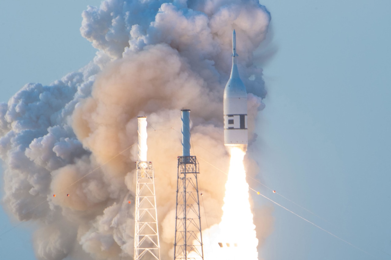 Vapor fills the sky as a rocket blasts off.