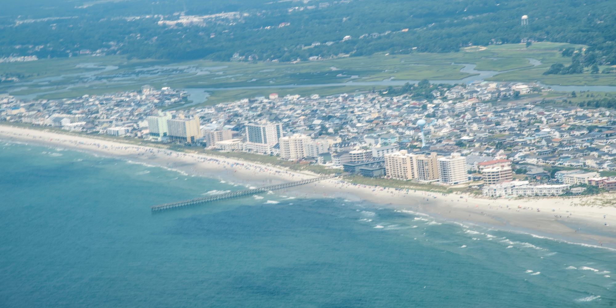 A C-17 Globemaster III from the 315th Airlift Wing at Joint Base Charleston, S.C. Flies down the coast of South Carolina near Myrtle Beach July 2, 2019.